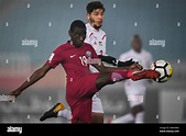 Almoez Ali Zainelabdeen Abdulla of Qatar kicks the ball to make a pass ...