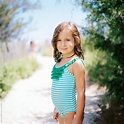 "Cute Young Girl Standing By A Beach Walkway In A Bathing Suit" by ...