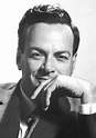 a black and white photo of a man in a suit with his hand on his chin