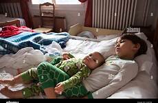 brother hotel bed sister baby lying alamy together
