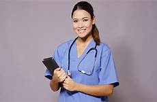 nurse doctor female scrubs ward rounds tablet smiling holding makes copy grey pc space she young over her