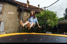 trampoline jumping girl teenage cute stock childhood concept alamy
