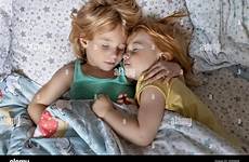 sleeping sibling embrace