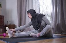 muslim yoga hijab fitness practicing woman bending mat sportswear tiptoes motivation touching strong lifestyle young beautiful