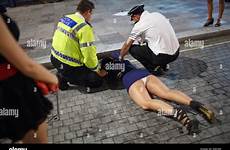 drunk woman women lying pavement policeman alamy london stock england night cardiff naked wales man sex weekend photography