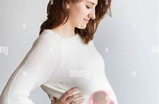 baby inside pregnant belly mothers mother superimposed newborn alamy