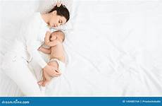 sleeping baby mom bed mother her young cute embracing preview
