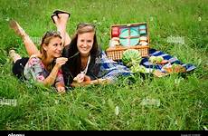 picnic girls attractive friends young two having dressed alamy stock lying lawn casual summer girl teasing