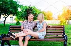 bench sitting woman park couple man hugging young people high