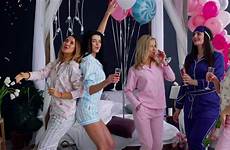 party pajama girls group dancing bachelorette laugh champagne swing glasses smile