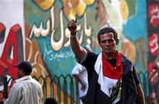 egypt revolution npr whitewashed wall erases casing bullet waves egyptian tahrir front man square