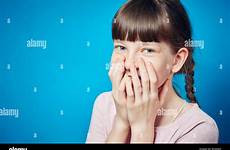 embarrassed girl shy cute hands covering emotional smiling mouth alamy portrait child young