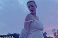 katy perry pregnant naked daisies nude her bump behind completely strips shows baby music off forced embraced tightly breeze lifted