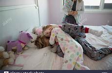 brother sister rough housing bed pajamas stock playful tickling alamy playing