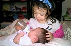 sister care baby taking her