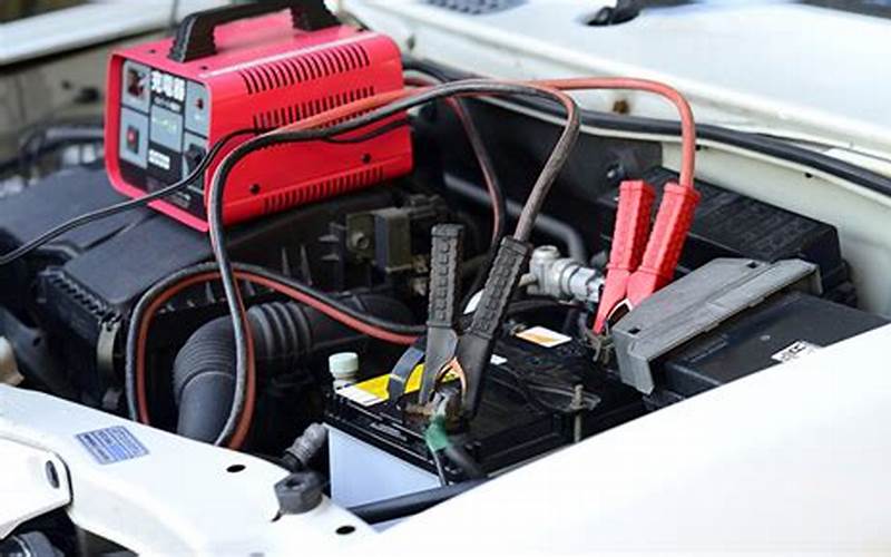 A Battery Charger Connected To A Car Battery