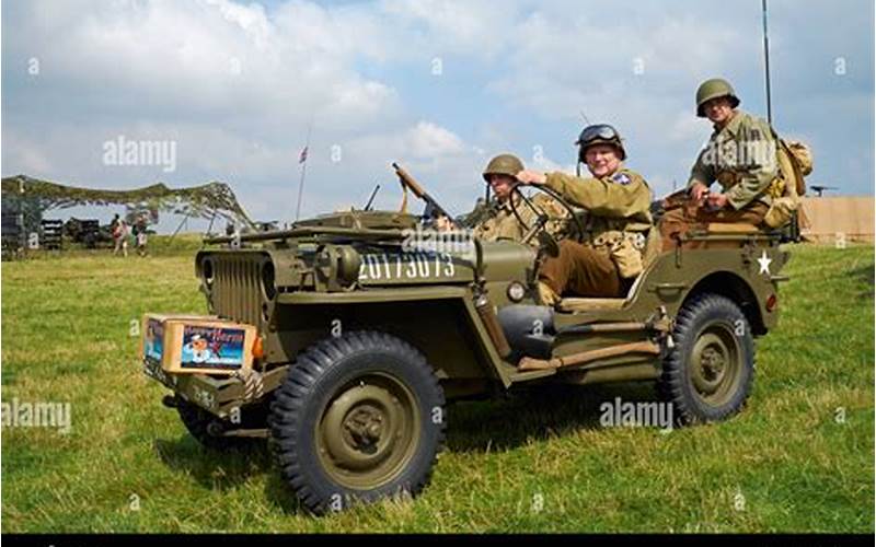 A Group Of Military Personnel Posing With A Jeep