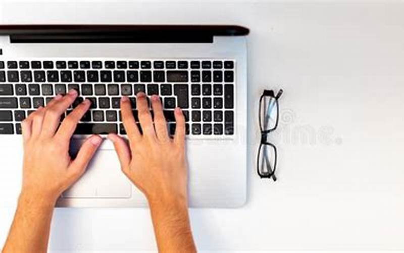 Blogger Typing On A Laptop