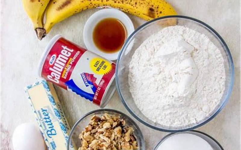 Various Ingredients Including Ripe Bananas, Peanut Butter, Flour, Sugar, And Eggs