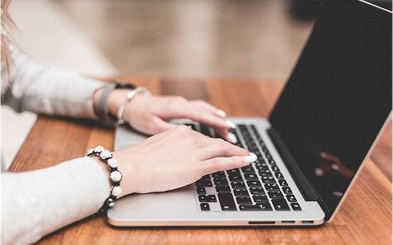 Woman Typing On Computer