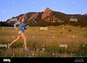 A woman trail runs just after sunrise in Boulder, Colorado Stock Photo ...