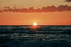 Half Sun Below Horizon Over Blue Sea Waves, Beautiful Sunset Over Sea ...