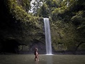 Woman in Red Bikini in Water Looking at Waterfall. Tibumana Waterfalls ...