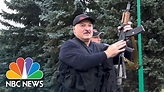 Lukashenko Arrives In Minsk Wielding Assault Rifle As Thousands In ...