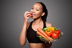 Happy healthy black asian woman eating vegetables - Dentists at Orenco Blog