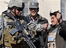 Sgt. 1st Class Vili Schwenke listens to an Afghan National Police ...