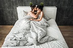 Couple in love kissing in bed containing bed, two, and attractive ...