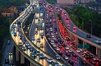 Traffic jam in the rush hour on highway. Cars on bridges and roads in ...