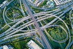 Aerial view of road interchange or highway intersection with busy urban ...