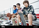Teenage boys sitting on bleachers Stock Photo - Alamy