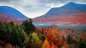 the mountains are covered with colorful trees and foliage in fall ...