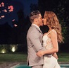 a man and woman are kissing in front of a pool at night with confetti ...