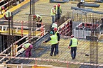 Men working at the construction site | Construction site, Construction ...