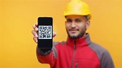 Delivery Man Wearing Helmet Showing Mobile Phone with QR Code on the ...