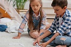 Little Caucasian boy and girl playing domino together - Stock Photo ...