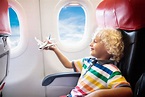 Child flying in airplane. Flight with kids. - HVN