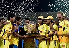 The Chennai Super Kings players pose with the IPL 2010 trophy ...