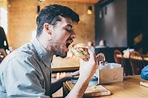 Man is Eating in a Restaurant and Enjoying Delicious Food Stock Photo ...