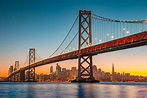 San Francisco skyline with Oakland Bay Bridge at sunset, California ...