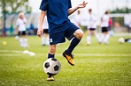 Niño jugando fútbol partido de fútbol en un estadio deportivo ...