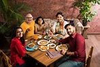 Premium Photo | Indian family eating food at dining table at home or ...
