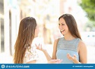 Two Happy Casual Friends Talking in the Street Stock Photo - Image of ...