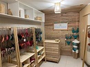 a room with wooden shelves filled with lots of shoes and bags on ...