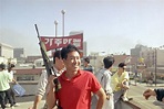 A Korean American carries a rifle to prevent rioters from entering a ...