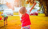 Child Standing on Green Lawn · Free Stock Photo