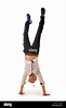 Young blond man standing upside down against of white background and ...